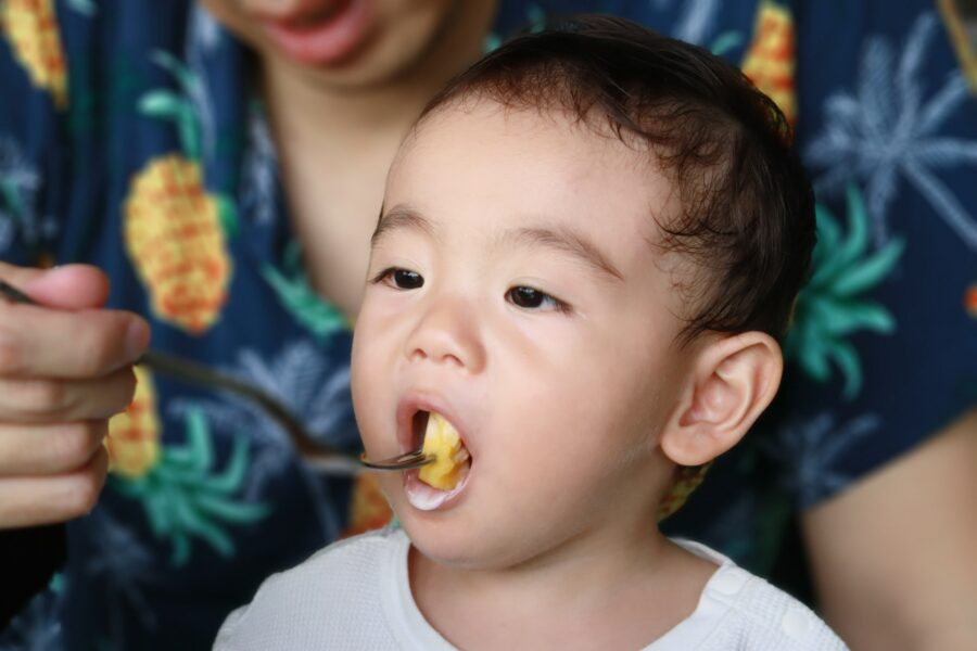 南国でフルーツを味わう子供